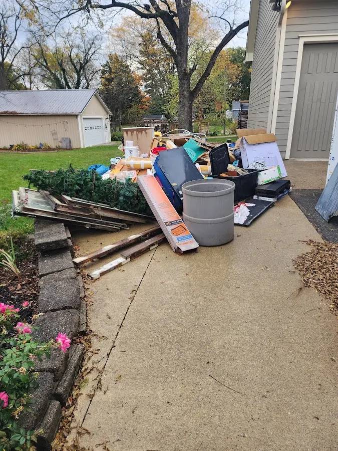 Dumpster being loaded with debris for Demolition Dumpster Rental in Devine